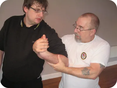 Instructor demonstrating a physical intervention technique on a student